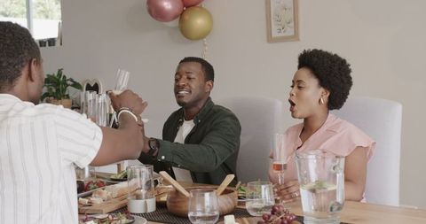 Friends Toasting with Champagne During Festive Home Gathering