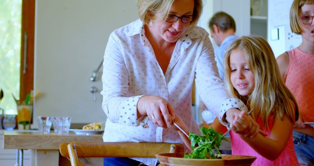 Grandmother and Granddaughter Preparing Salad in Kitchen - Download Free Stock Images Pikwizard.com