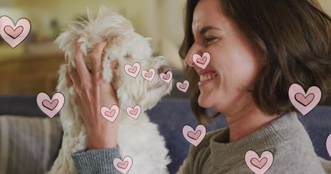Woman Cuddling with Dog at Home Surrounded by Hearts