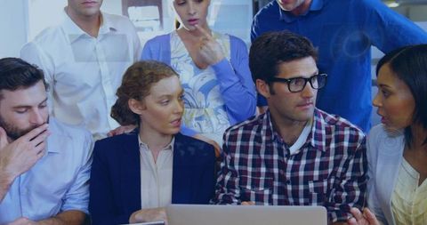 Team Collaborating on Project Ideas with Laptop in Modern Office