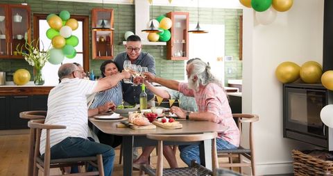Diverse Happy Seniors Celebrating Together With Toast