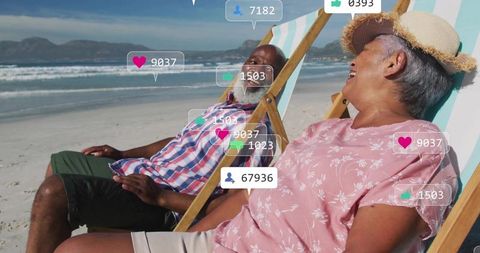 Elderly Couple Relaxing on Sandy Beach with Social Media Icons