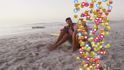 Surfers Relaxing on Beach with Colorful Emoji Overlay