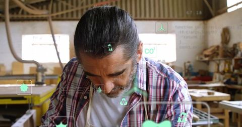 Veteran craftsman with digital interface in woodworking workshop