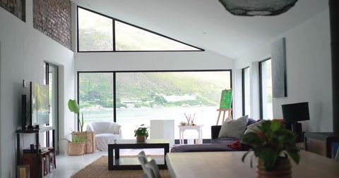 Coastal lounge framing waterfront view through floor-to-ceiling glass wall