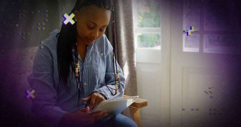 Woman using tablet with digital glitch effects at home