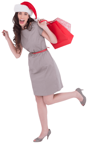 Festive Woman in Dress and Santa Hat Holding Shopping Bag