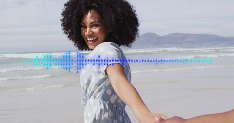 Joyful Woman Walking on Beach Holding Hands with Partner