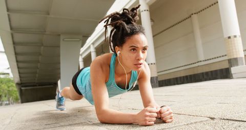 Motivated Athlete Performing Plank Listening to Music Outdoor - Download Free Stock Images Pikwizard.com