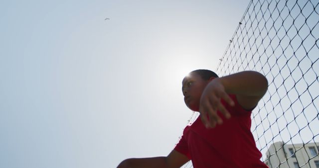 Youth Playing Behind Net Under Bright Sun - Download Free Stock Images Pikwizard.com