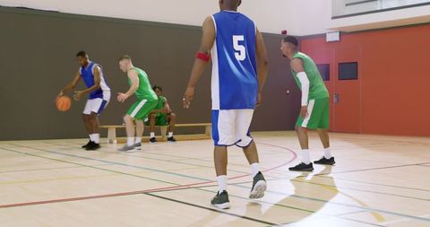 African american basketball team competing on indoor court dribbling passing rebounding