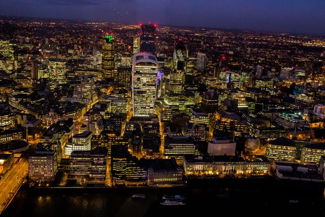 Capturing the breathtaking London skyline at night, illuminated buildings and skyscrapers, and the Thames River. Perfect for travel magazines, cityscape portfolios, and websites promoting London tourism or urban architecture.