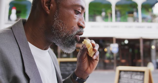 Man Eating a Sandwich Outdoors at Bistro Cafe - Download Free Stock Images Pikwizard.com