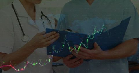 Medical Professionals Analyzing Data Charts in Hospital Corridor