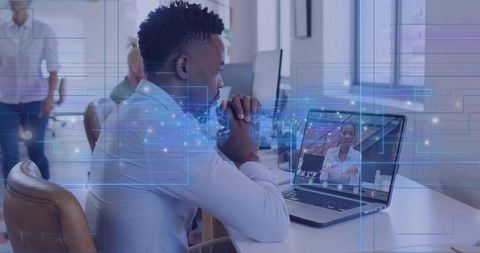 Remote team member participating in virtual meeting at modern office with digital overlay