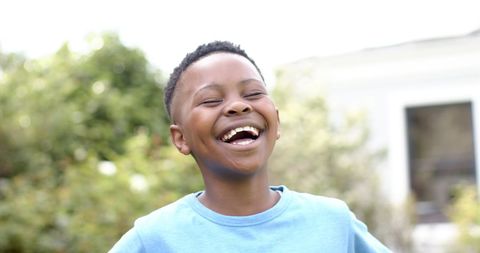Joyful African American Boy Laughing Outdoors on Sunny Day - Download Free Stock Images Pikwizard.com