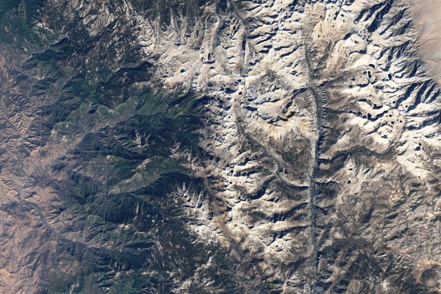 This detailed aerial view of Sequoia National Park in California beautifully highlights the mixed terrain of peaks and valleys, as well as snow-covered mountainsides and verdant forests captured by NASA's Landsat 5 satellite. Sitting at the southern end of the Sierra Nevada, the park shelters giant sequoia trees and supports diverse ecosystems. Useful in nature documentaries or travel guides highlighting California's natural attractions, environmental research publications, or educational materials showing various terrain features and their seasonal transformations.