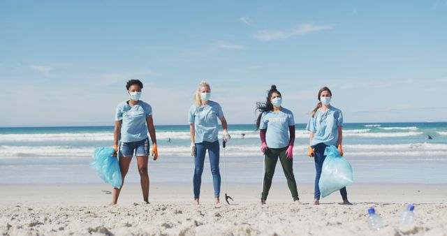 Diverse group of volunteers cleaning up a beach while wearing masks and gloves. Useful for campaigns promoting environmental conservation, community service, and teamwork. Ideal for illustrating citizen environmental efforts.