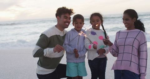Joyful Family Enjoying Sparklers at Sunset Beach