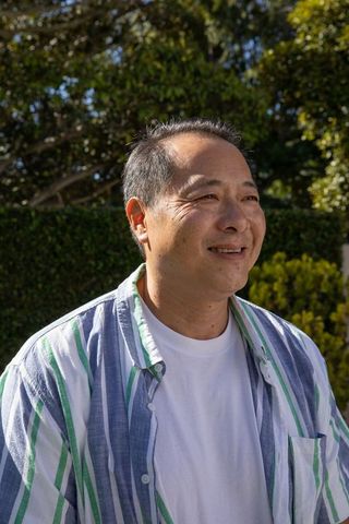 Mature Man Enjoying Sunny Day in Tranquil Garden Ambience