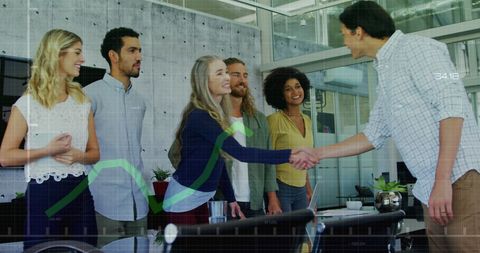 Executives Shaking Hands with Colleagues in Modern Office Environment