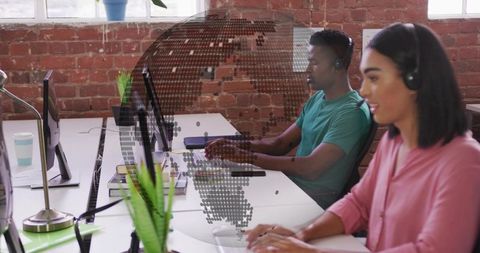Remote support team working in modern open-plan office with headsets and collaboration