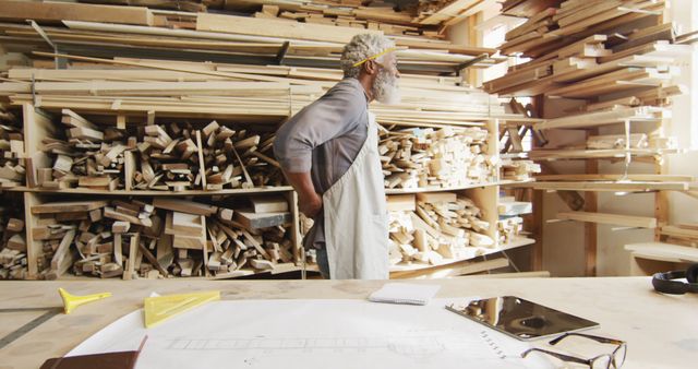 Experienced Woodworker Assessing Lumber in Workshop - Download Free Stock Images Pikwizard.com