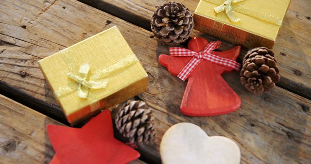A golden gift box and Christmas decor on wood convey holiday warmth with space for text. - Download Free Stock Photos Pikwizard.com