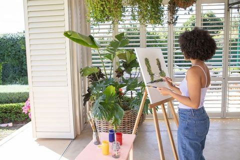 Woman Painting Botanical Art on Sunny Veranda with Eucalyptus