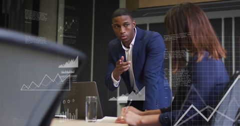 Colleagues Discussing Financial Data with Digital Interface Graphics