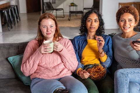 Diverse Friends Enjoying Cozy Time Together on Sofa