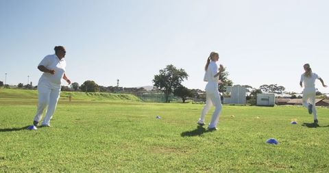 Female Athletes in Sports Uniform Running Cone Training