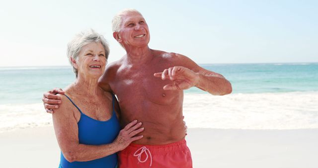 Senior couple enjoying beach vacation embracing and smiling - Download Free Stock Images Pikwizard.com