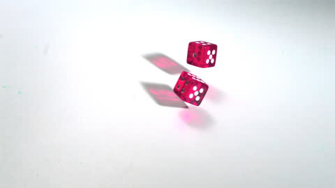 Pink Dice Rolling in Slow Motion Across White Surface