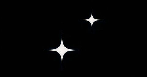 Minimalist four-point stars featuring negative space on black canvas for modern design