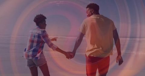 Couple Holding Hands on Beach with Abstract Overlay