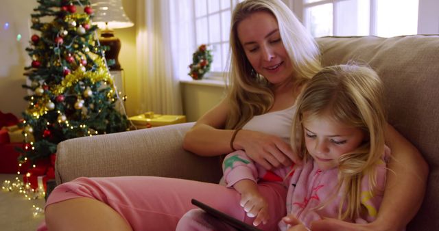 Mother and Daughter Bonding at Christmas Time on Sofa - Download Free Stock Images Pikwizard.com