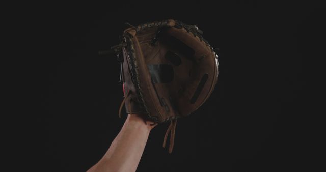Hand Holding Baseball Glove Against Black Background - Download Free Stock Images Pikwizard.com