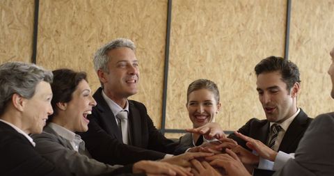 Business team unites with motivational hand gesture