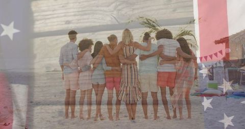 Group embracing on beach with american flag overlay celebrating summer friends reunion