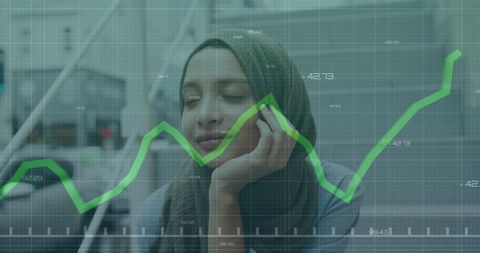 Businesswoman Analyzing Financial Graph with Digital Overlay