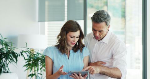 Business Professionals Collaborating on Digital Tablet in Contemporary Office - Download Free Stock Images Pikwizard.com