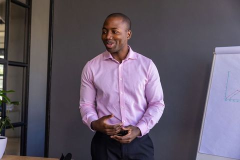 Confident professional discussing business strategy in meeting room