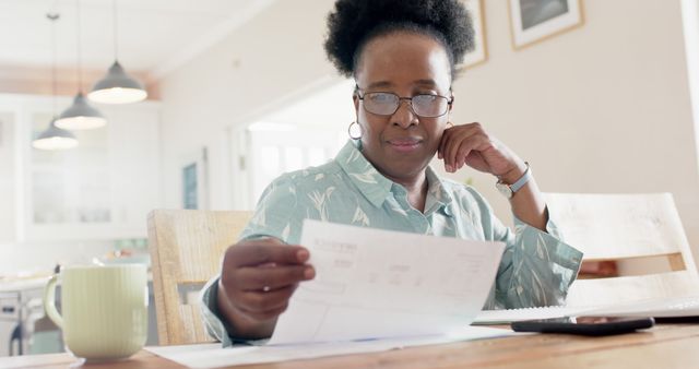 Senior African American Woman Reviewing Finances at Home - Download Free Stock Images Pikwizard.com
