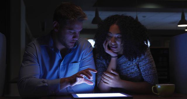 Colleagues Discussing Work Late at Night Using Tablet - Download Free Stock Images Pikwizard.com