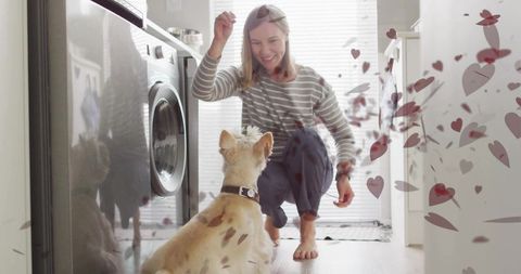 Woman training dog in cozy laundry room with hearts overlay