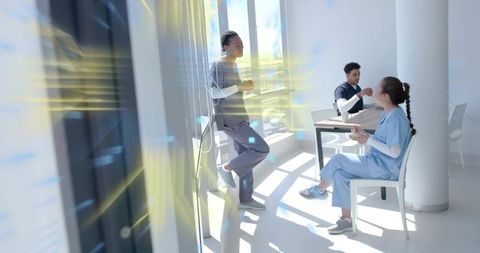 Healthcare Professionals Socializing in Modern Break Room Setting