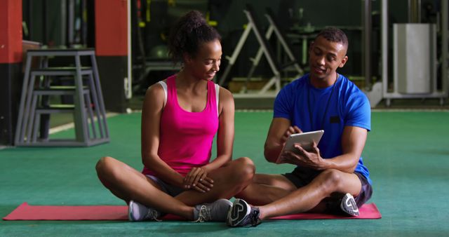 Fitness Trainer Coaching Woman Using Tablet at Gym - Download Free Stock Images Pikwizard.com