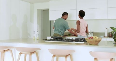 Couple Cooking Together in Modern Kitchen with Island