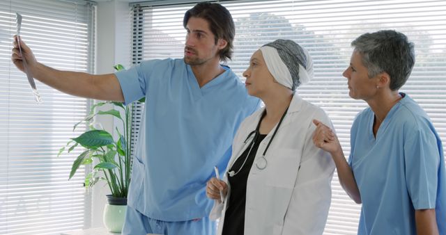 Medical team examining x-ray with concerned patient in hospital - Download Free Stock Images Pikwizard.com